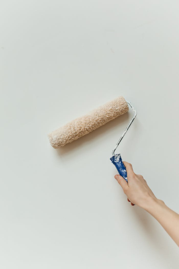 A Person Holding a Roller Paint